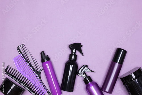 Fototapeta Naklejka Na Ścianę i Meble -  Hair care and styling products with combs layout on purple background. Copy space