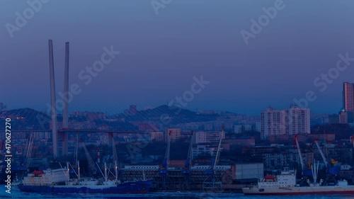 Full moon dawn over Vladivostok. Time Laps. The full moon rises over a large city in winter. photo