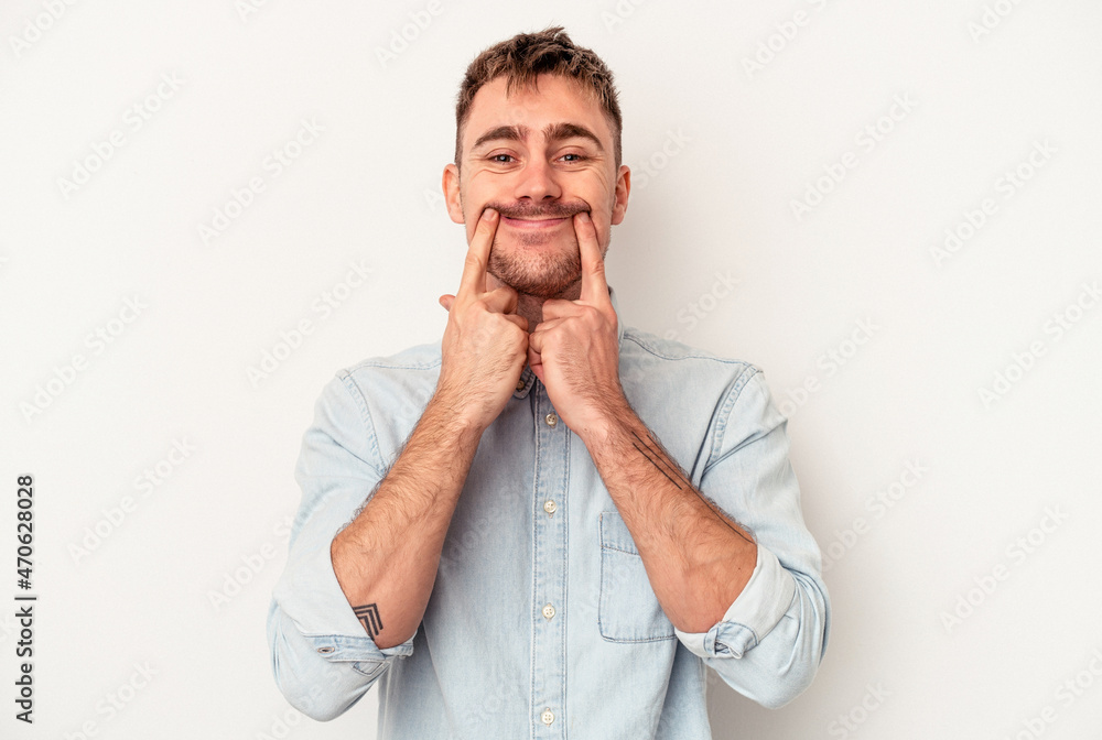 Young caucasian man isolated on white background blink through fingers frightened and nervous.