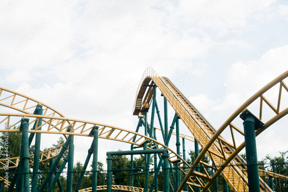 close-up image of a rollercoaster track and the blue sky close-up image of a rollercoaster track and the blue sky