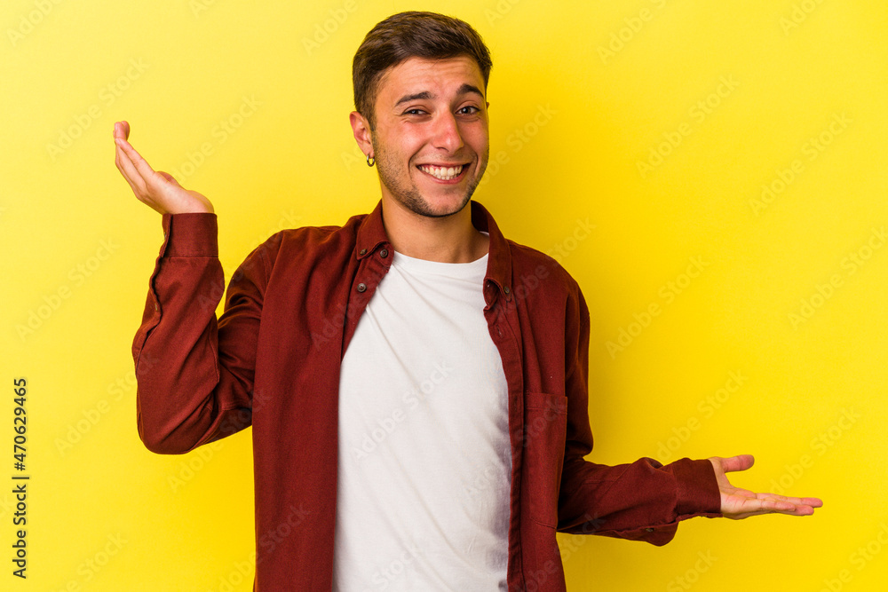 Young caucasian man with tattoos isolated on yellow background confused and doubtful shrugging shoulders to hold a copy space. Young caucasian man with tattoos isolated on yellow background confused and doubtful shrugging shoulders to hold a copy space.