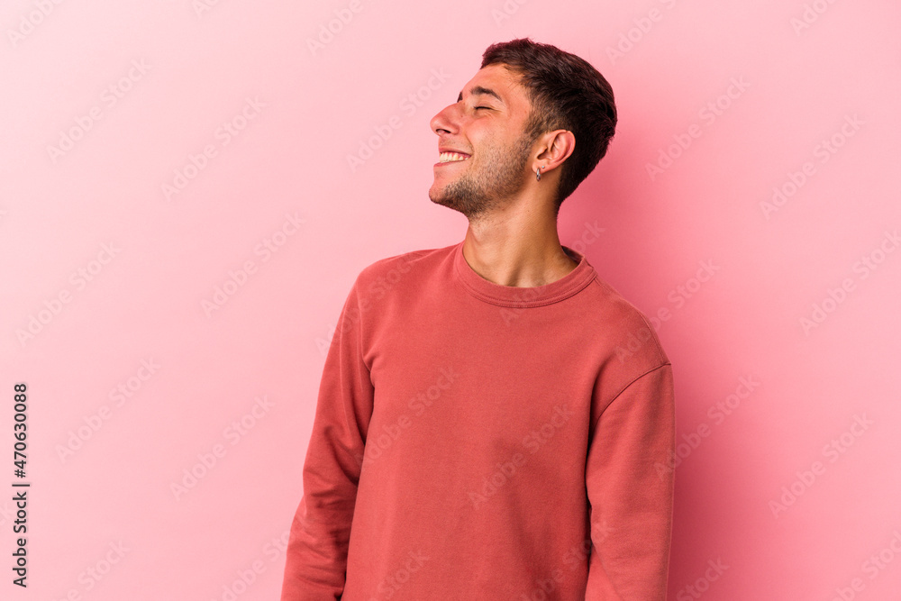 Young caucasian man with tattoos isolated on yellow background relaxed and happy laughing, neck stretched showing teeth. Young caucasian man with tattoos isolated on yellow background relaxed and happy laughing, neck stretched showing teeth.