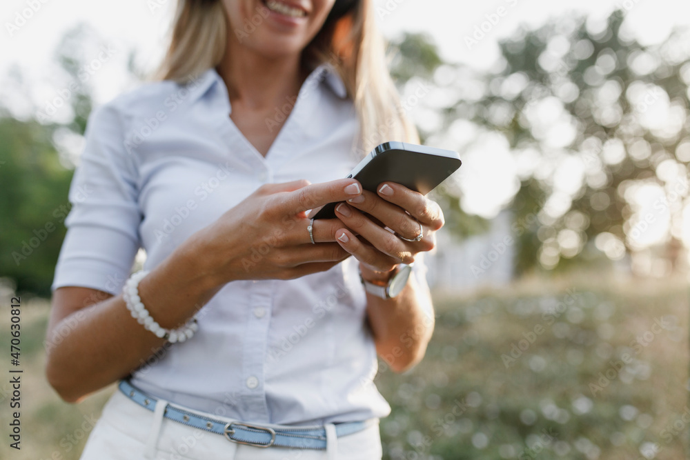 Woman in white casual using smart phone Woman in white casual using smart phone