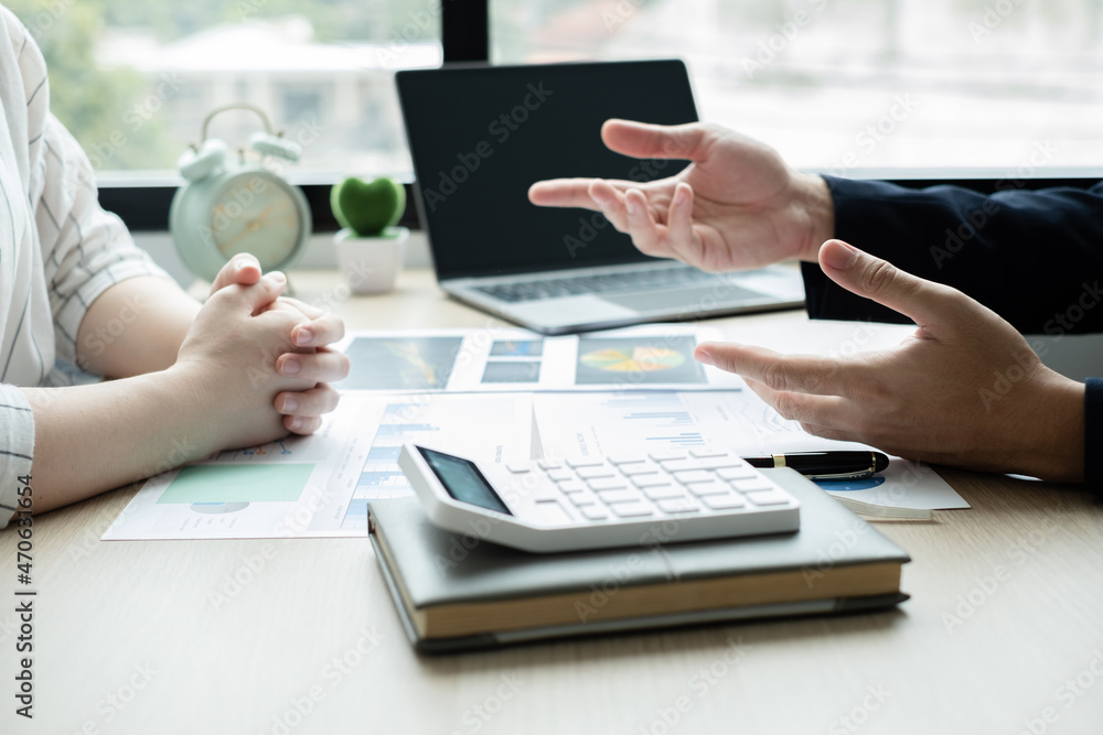 Two business leaders talk about charts, financial graphs showing results are analyzing and calculating planning strategies, business success building processes Two business leaders talk about charts, financial graphs showing results are analyzing and calculating planning strategies, business success building processes