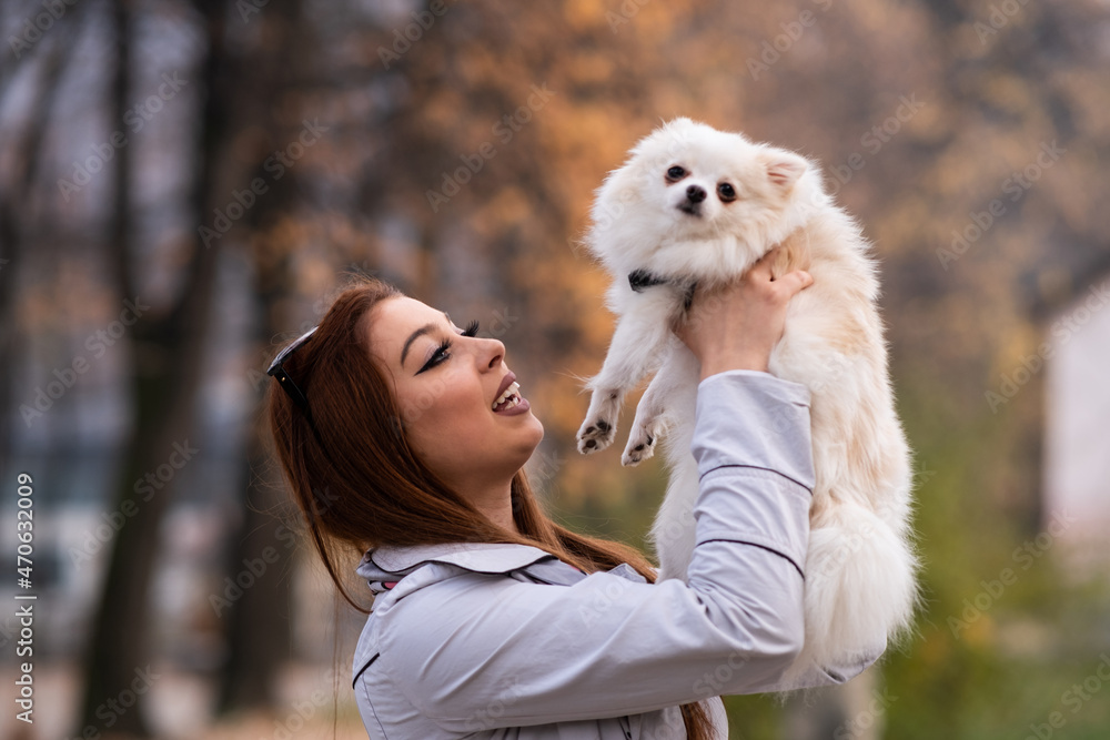 young women hold dog in park young women hold dog in park