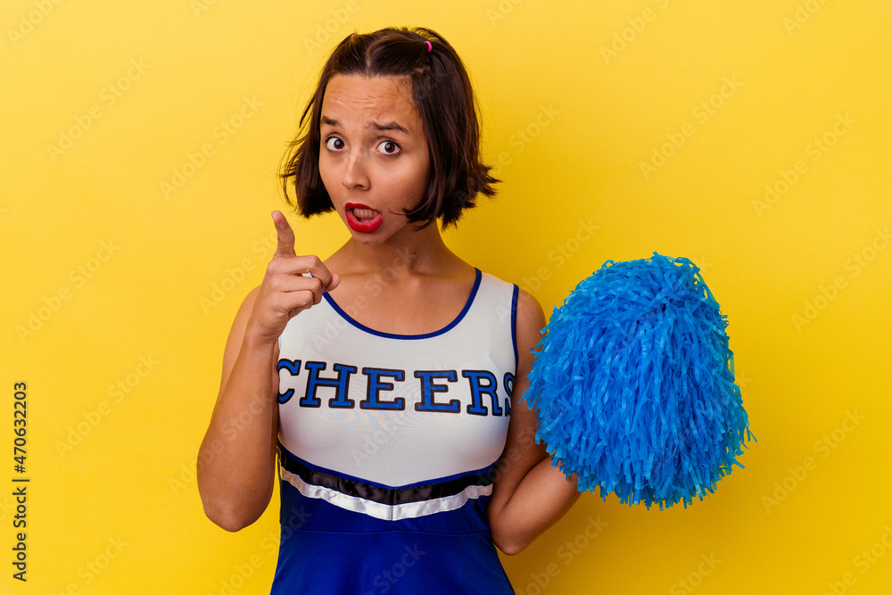Young cheerleader mixed race woman isolated on yellow background having an idea, inspiration concept. Young cheerleader mixed race woman isolated on yellow background having an idea, inspiration concept.