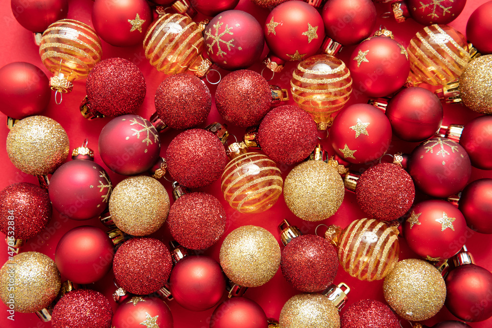 Christmas balls on red color background. Xmas baubles variety, red and golden colors, top view. Christmas balls on red color background. Xmas baubles variety, red and golden colors, top view.