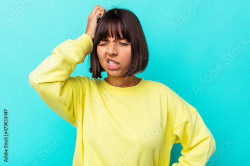 Young mixed race woman isolated on blue background celebrating a victory, passion and enthusiasm, happy expression.