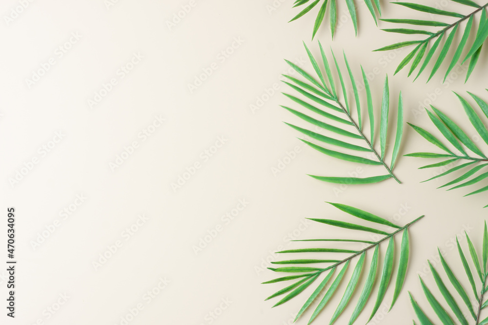 Cosmetic background with palm leaf on pastel beige. Flat lay, copy space