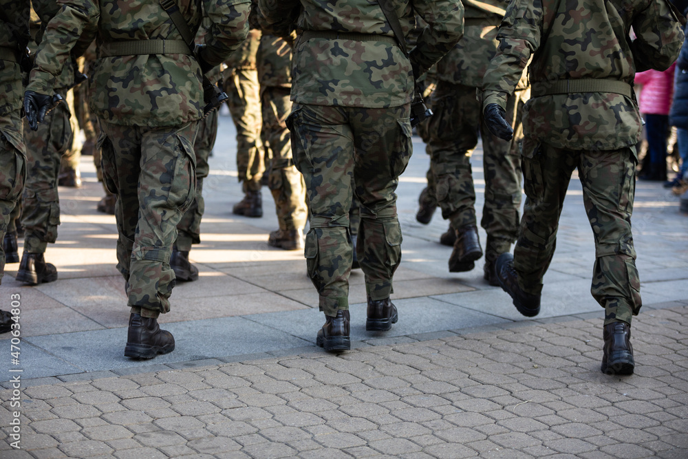 Rear view of marching soldiers in full uniform. Rear view of marching soldiers in full uniform.