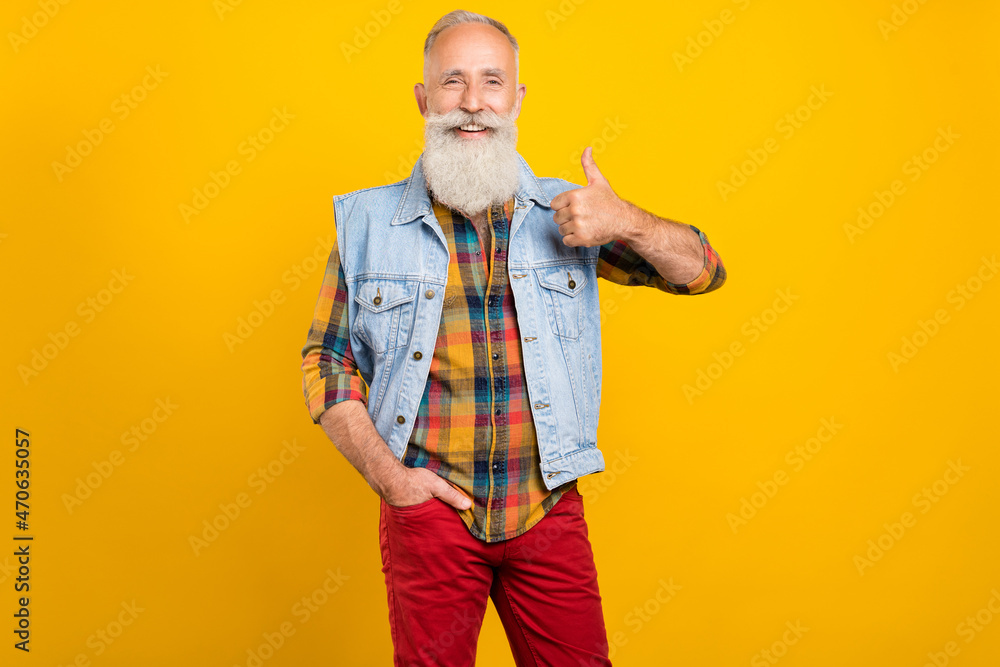 Photo of retired man show thumb-up select advise great recommendation ad isolated over yellow color background Photo of retired man show thumb-up select advise great recommendation ad isolated over yellow color background