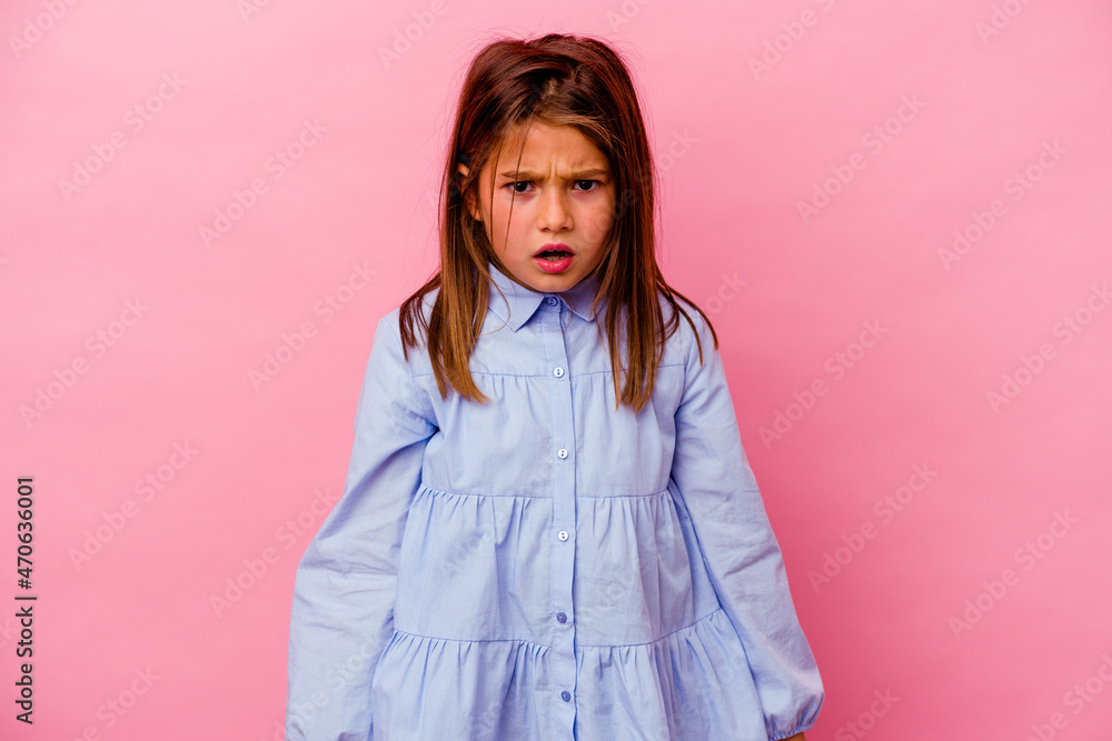 Little caucasian girl isolated on pink background screaming very angry and aggressive. Little caucasian girl isolated on pink background screaming very angry and aggressive.