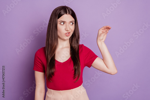 Photo of angry aggressive girl look empty space mock hand show talk more sign on violet background