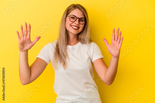 Young russian woman isolated on yellow background celebrating a victory or success, he is surprised and shocked.