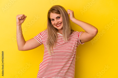 Young russian woman isolated on yellow background dancing and having fun.
