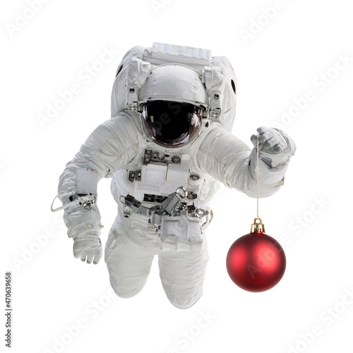 Astronaut in space suit holds christmas ball