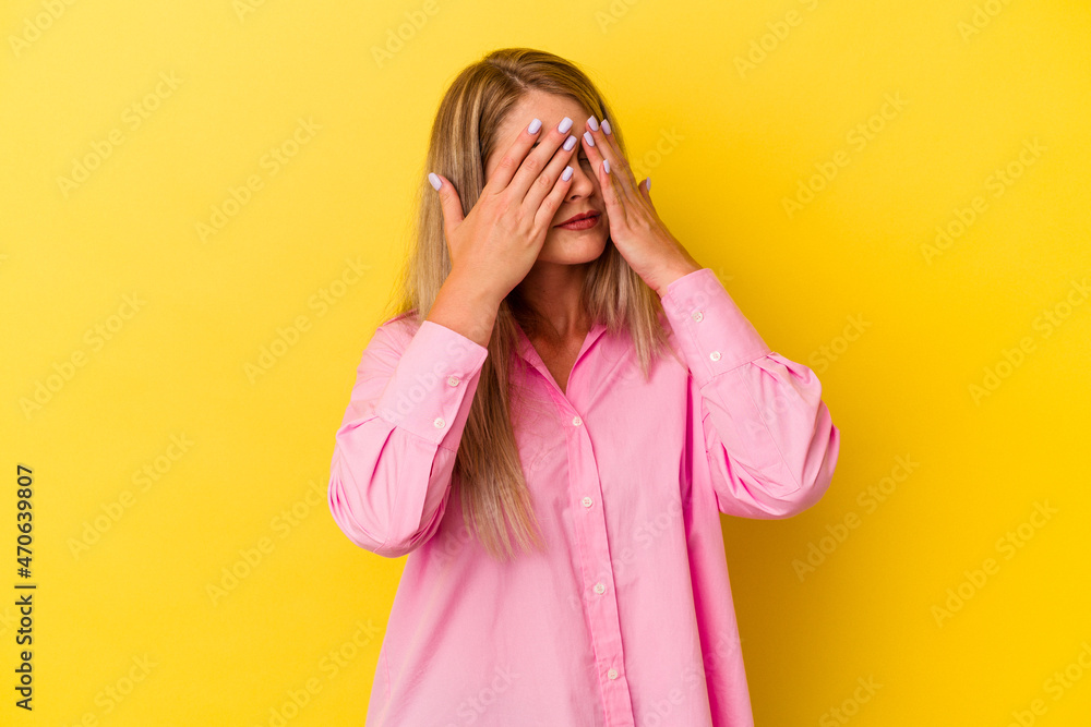 Young russian woman isolated on yellow background afraid covering eyes with hands. Young russian woman isolated on yellow background afraid covering eyes with hands.
