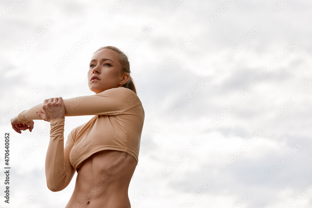 The blonde poses for the camera, in between workouts. Attractive athletic woman exercising outdoors in the morning, copy space. Health, fitness concept, copy space. close-up. The blonde poses for the camera, in between workouts. Attractive athletic woman exercising outdoors in the morning, copy space. Health, fitness concept, copy space. close-up.