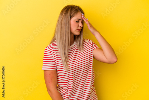 Young russian woman isolated on yellow background forgetting something, slapping forehead with palm and closing eyes.