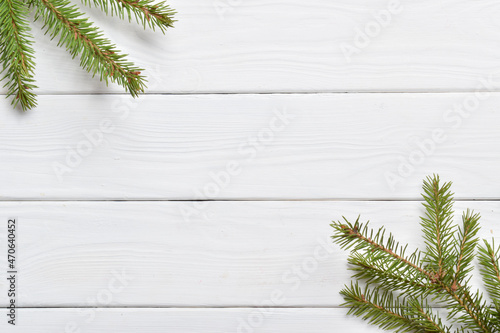 White wooden table and fir branches.