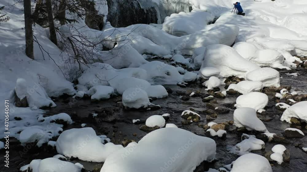 Video from drone of Photographer with tripod and camera takes pictures of the waterfall. Siberia, Russia Video from drone of Photographer with tripod and camera takes pictures of the waterfall. Siberia, Russia