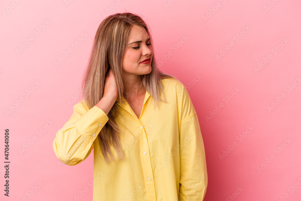 Young russian woman isolated on pink background having a neck pain due to stress, massaging and touching it with hand. Young russian woman isolated on pink background having a neck pain due to stress, massaging and touching it with hand.