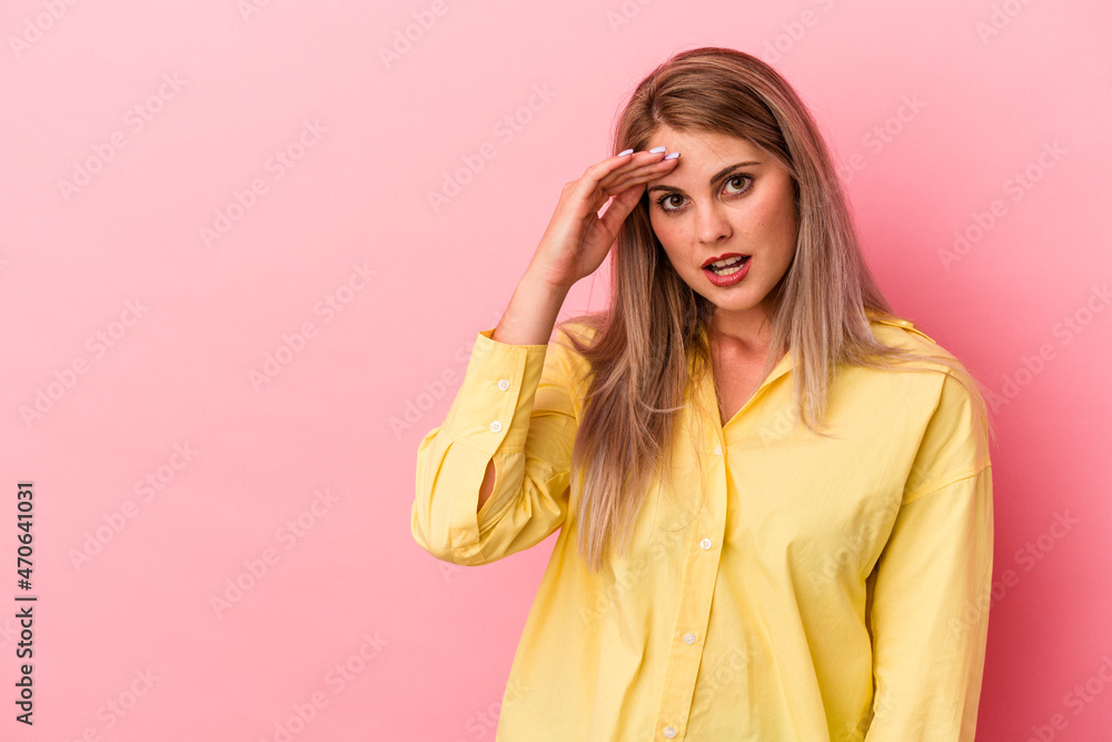 Young russian woman isolated on pink background looking far away keeping hand on forehead. Young russian woman isolated on pink background looking far away keeping hand on forehead.
