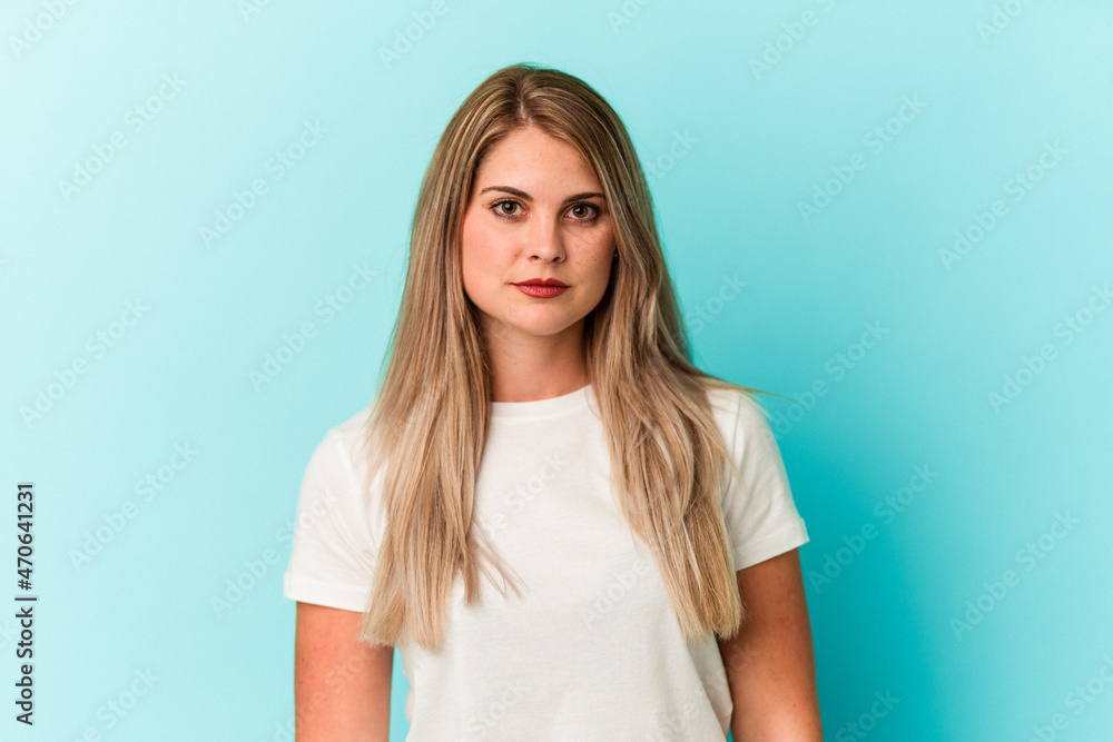 Young russian woman isolated on blue background Young russian woman isolated on blue background