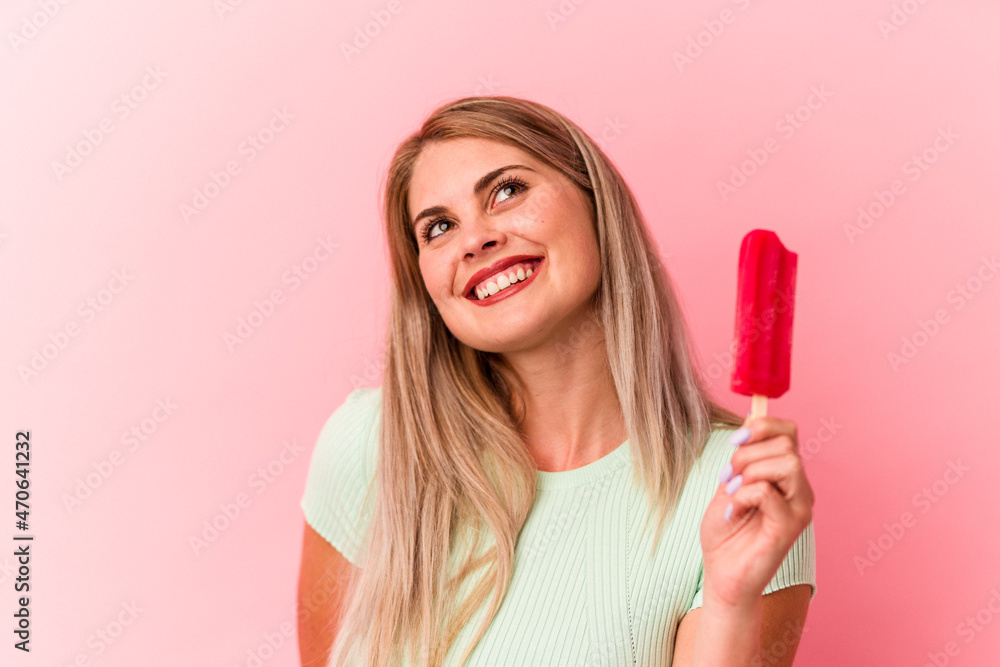 Young russian woman holding an ice cream isolated on pink background Young russian woman holding an ice cream isolated on pink background