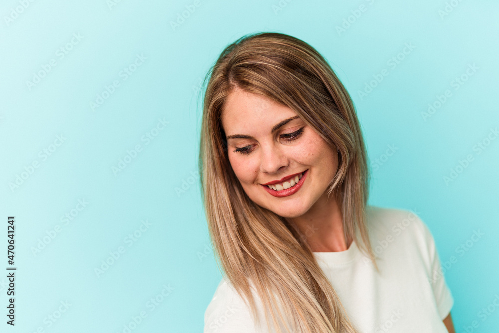 Young russian woman isolated on blue background Young russian woman isolated on blue background