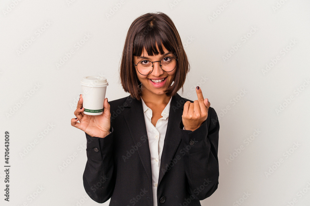 Young mixed race business woman holding a coffee isolated on white background pointing with finger at you as if inviting come closer. Young mixed race business woman holding a coffee isolated on white background pointing with finger at you as if inviting come closer.