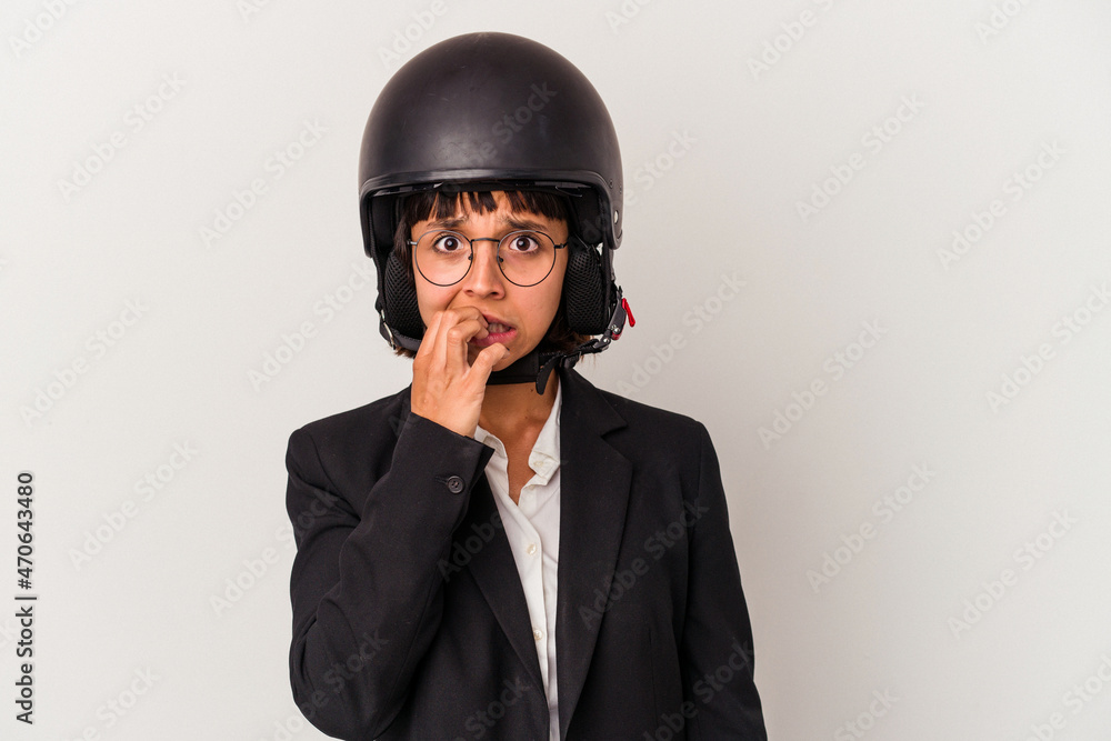 Young mixed race business woman wearing a motorbike helmet isolated biting fingernails, nervous and very anxious. Young mixed race business woman wearing a motorbike helmet isolated biting fingernails, nervous and very anxious.