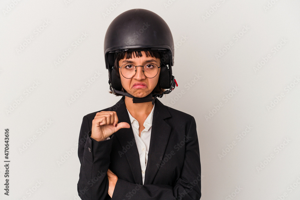 Young mixed race business woman wearing a motorbike helmet isolated showing a dislike gesture, thumbs down. Disagreement concept. Young mixed race business woman wearing a motorbike helmet isolated showing a dislike gesture, thumbs down. Disagreement concept.