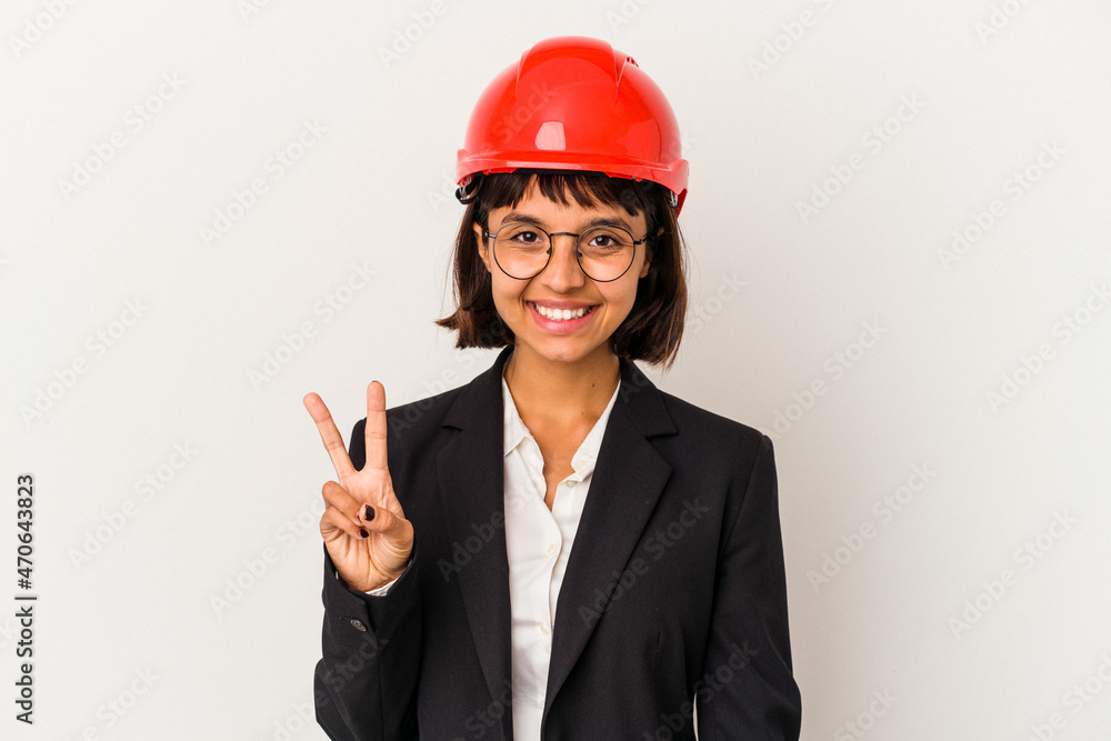 Young architect woman with red helmet isolated on white background showing victory sign and smiling broadly. Young architect woman with red helmet isolated on white background showing victory sign and smiling broadly.