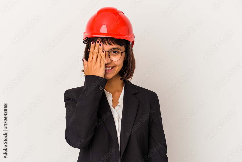 Young architect woman with red helmet isolated on white background having fun covering half of face with palm. Young architect woman with red helmet isolated on white background having fun covering half of face with palm.