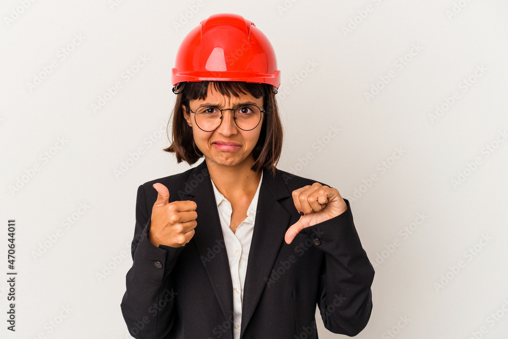 Young architect woman with red helmet isolated on white background showing thumbs up and thumbs down, difficult choose concept Young architect woman with red helmet isolated on white background showing thumbs up and thumbs down, difficult choose concept