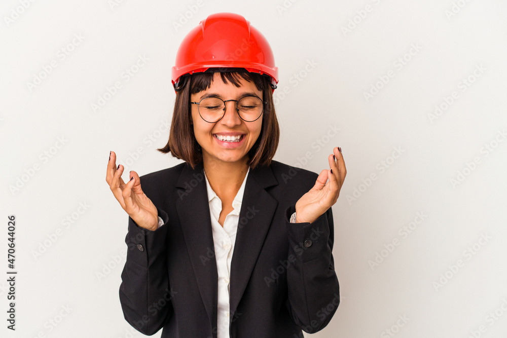 Young architect woman with red helmet isolated on white background joyful laughing a lot. Happiness concept. Young architect woman with red helmet isolated on white background joyful laughing a lot. Happiness concept.