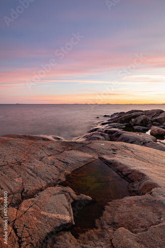 Rocky coast of the Gulf of Finland at sunset, summer in Finland