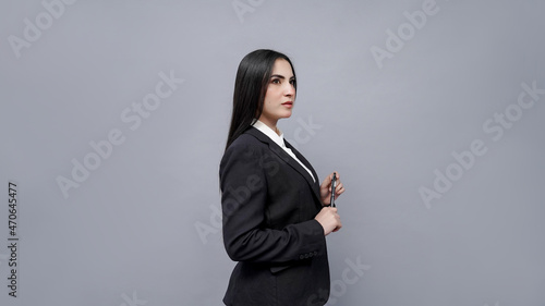 young businesswomen side pose  wearing black coat indian pakistani model photo