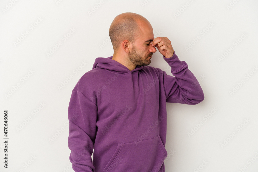 Young bald man isolated on white background having a head ache, touching front of the face. Young bald man isolated on white background having a head ache, touching front of the face.