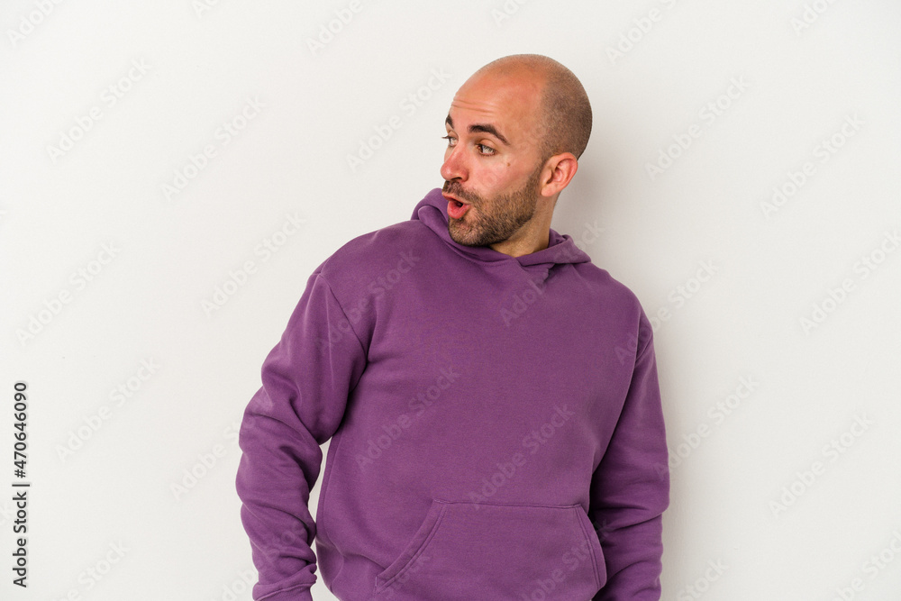 Young bald man isolated on white background looks aside smiling, cheerful and pleasant. Young bald man isolated on white background looks aside smiling, cheerful and pleasant.
