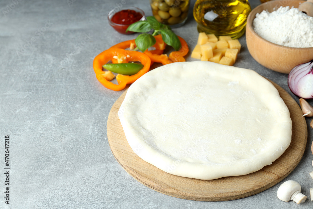 Concept of cooking pizza on gray textured background Concept of cooking pizza on gray textured background