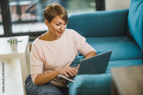 Woman Using Laptop While Sitting At Home