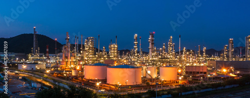 Aerial view. Oil refinery factory and oil storage tank at twilight and night. Petrochemical Industrial. Banner panorama.