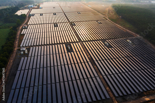 Aerial view of large solar panels at solar farm at sunrise in sunny spring. Solar cell power plants alternative electricity source - concept