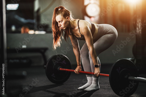 Fit Woman Weightlifting At The Gym