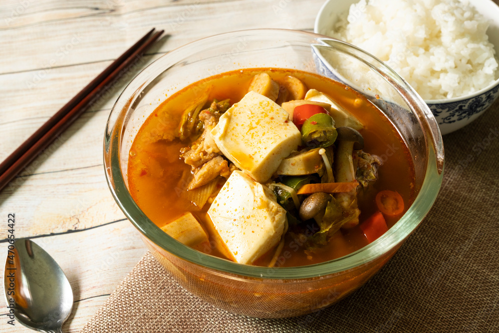 Korean soup, kimchi, tofu, pork with steamed rice