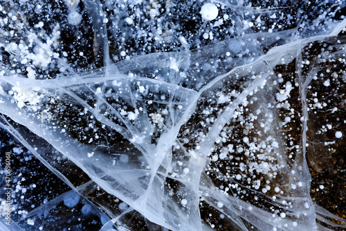 Methane bubbles in the Baikal ice. Cracks on the surface of lake.