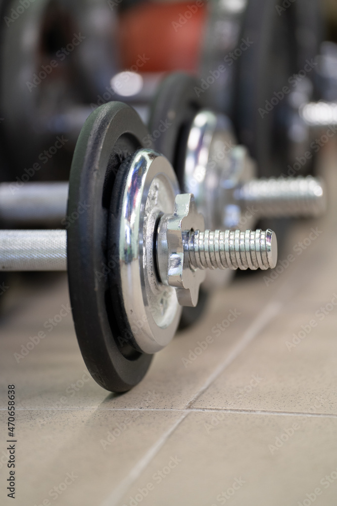 Fototapeta premium Black dumbbells on the gym floor