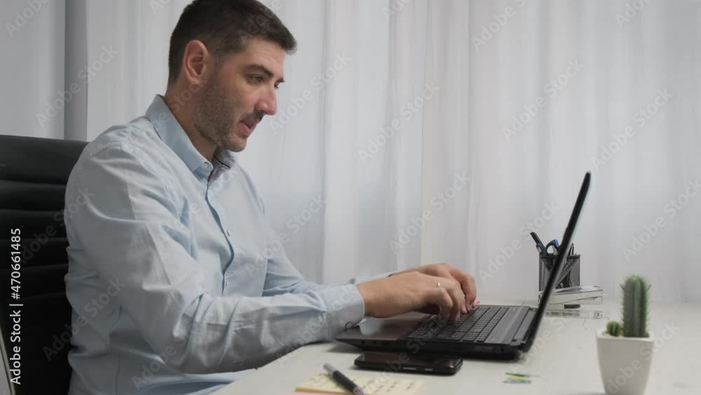 Angry stressed businessman wearing blue shirt, Annoyed with laptop problem - working from home Angry stressed businessman wearing blue shirt, Annoyed with laptop problem - working from home